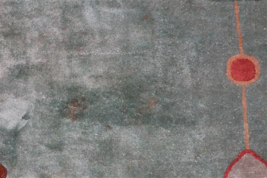 A Chinese carpet, the centre woven with flowering prunus and other shrubs on a celadon ground, within 477 x 385cm